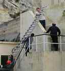 Up, up & way: ladder loaded as the crew get cracking to rig up their second HF antenna.