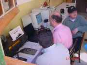 Ray, 9H1EI, on the station's e-log; Silvio looks on.